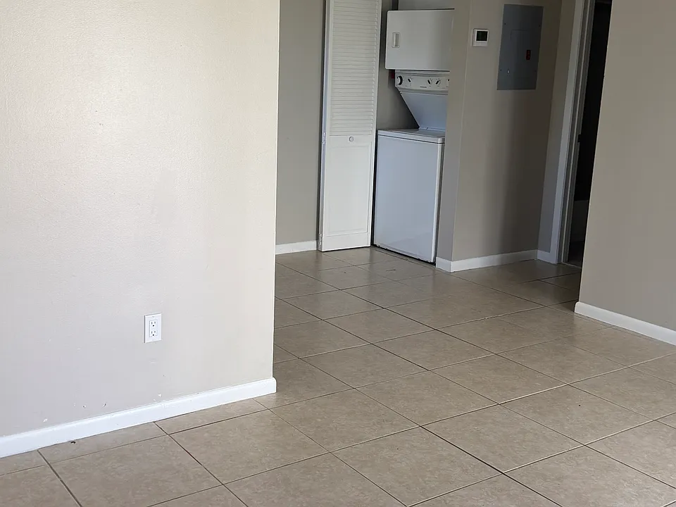 Living room looking towards bedroom with appliance closet open. Sorry about the hand obstruction.