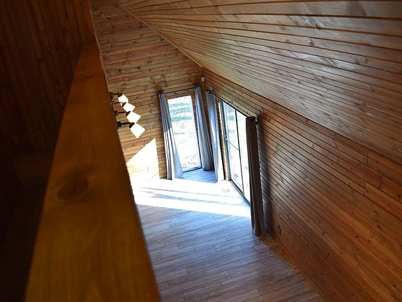 Family Room with lots of wood on walls and ceilings