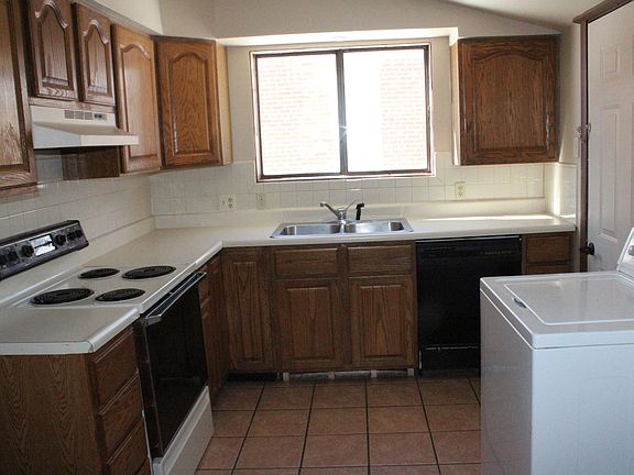 Ample kitchen counter space with washer, dryer, and dishwasher.