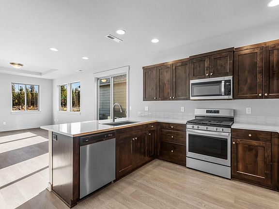 Kitchen 
Note: the subject property has white cabinets; not brown as are shown in this stock photo. Also, there is room for bar stools at the kitchen counter.