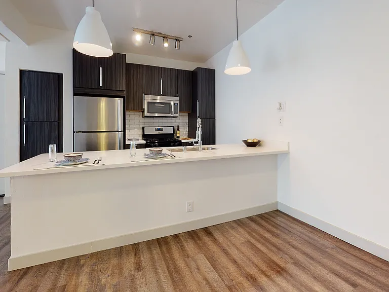 Reimagined kitchen with granite countertops and stainless steel appliances.