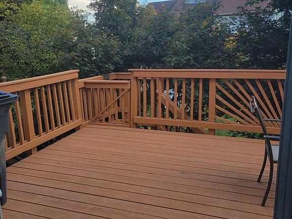 Beautiful back deck off the combo Living/Dining room, on main level of this home. Enjoy the park-like setting!