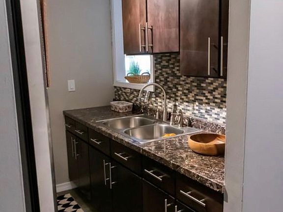 wood cabinets and marble finish counter top