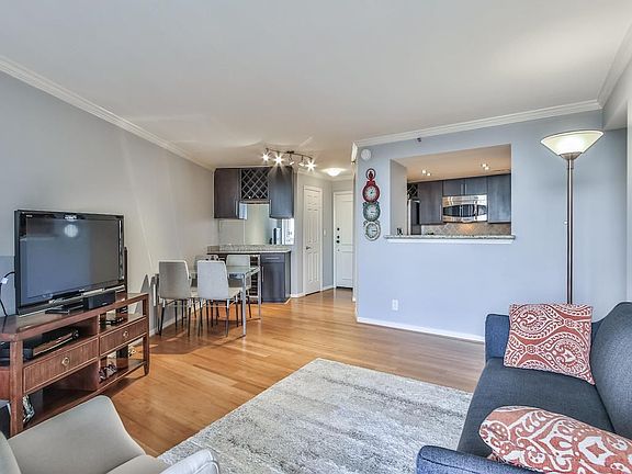 Dry bar with wine refrigerator & storage with easy flow from the kitchen to living area makes for great entertaining space.