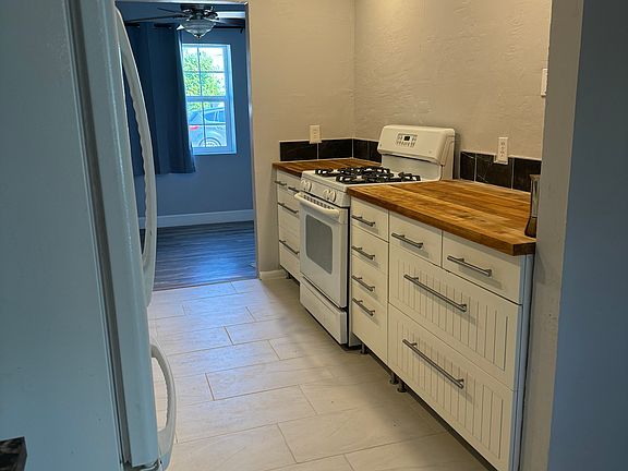 Galley kitchen opens into dining area in living room and bonus room.