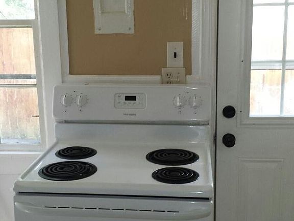 Stove and storage in the kitchen with tile flooring