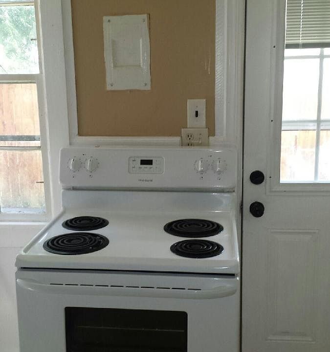 Stove and storage in the kitchen with tile flooring