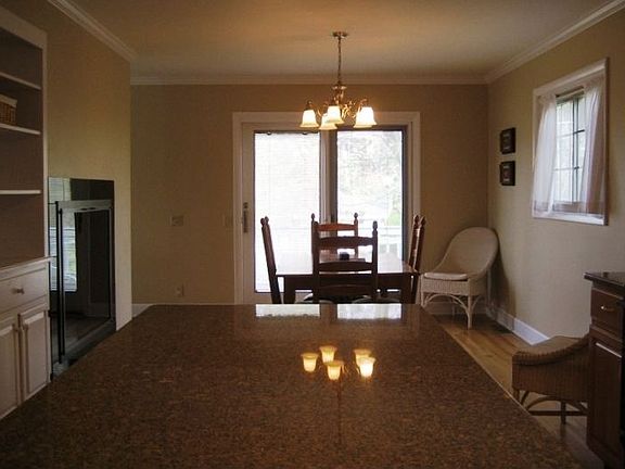 Dining area open to Kitchen warmed by opposite side of gas fireplace