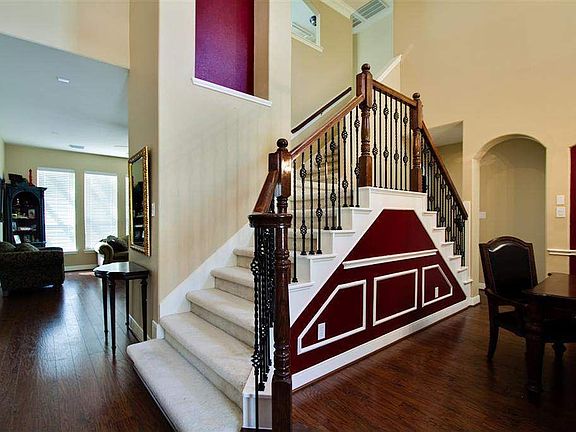  Dramatic two story entry with wrought iron double staircase 