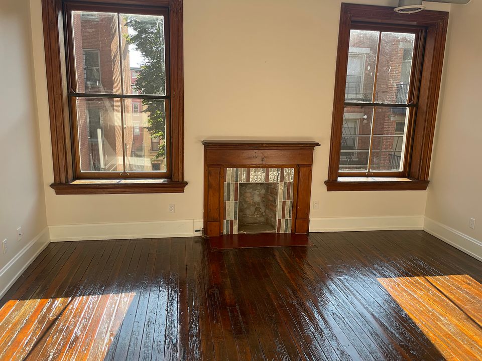 2-story living room with artisan tiled fireplace