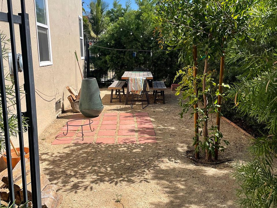 A more recent photo of the private outdoor patio. Maturing hedges offer excellent privacy.