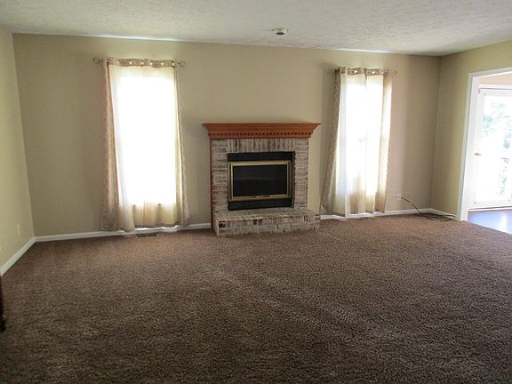 Great room w/ fireplace. View to dining room