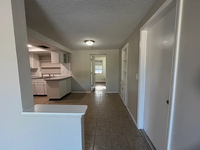 From the family room, you will walk into the kitchen, or take the door on the right into the garage...or walk straight back into the master bedroom and bath