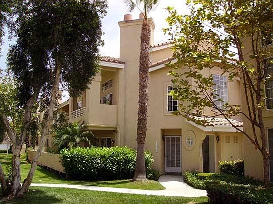 view of main room upstairs balcony, upstairs windows and ground floor entrance door