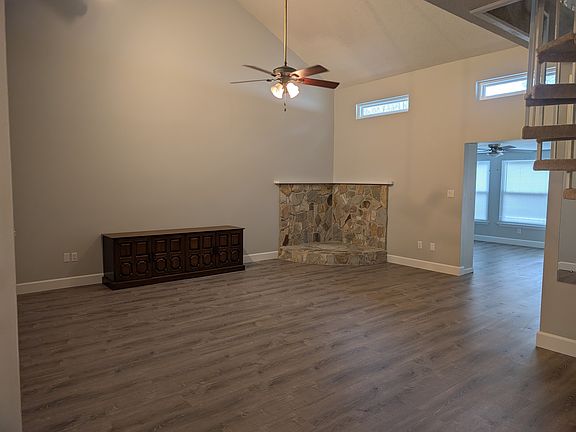 Very large living room with vaulted ceiling give this room a spacious feel. Stonework used to support a wood-burning fireplace. Great place for a Christmas tree or other room accents.