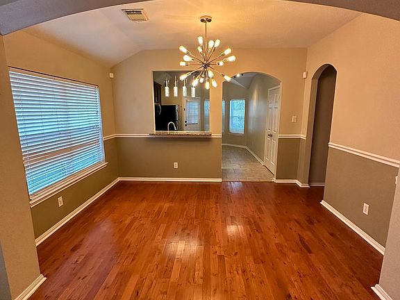 Formal dining area with wood floors