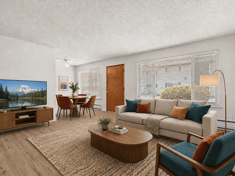 Spacious living room with a dedicated dining area in a one-bedroom deluxe apartment at Palisades Apartments in Tacoma.