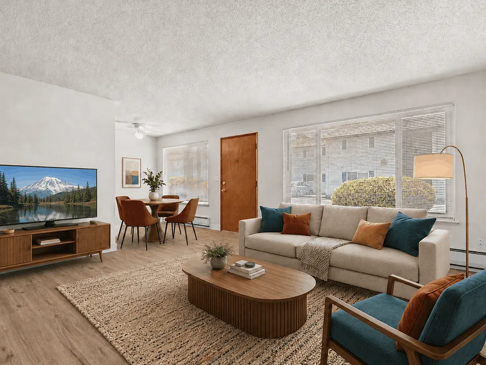 Spacious living room with a dedicated dining area in a one-bedroom deluxe apartment at Palisades Apartments in Tacoma.