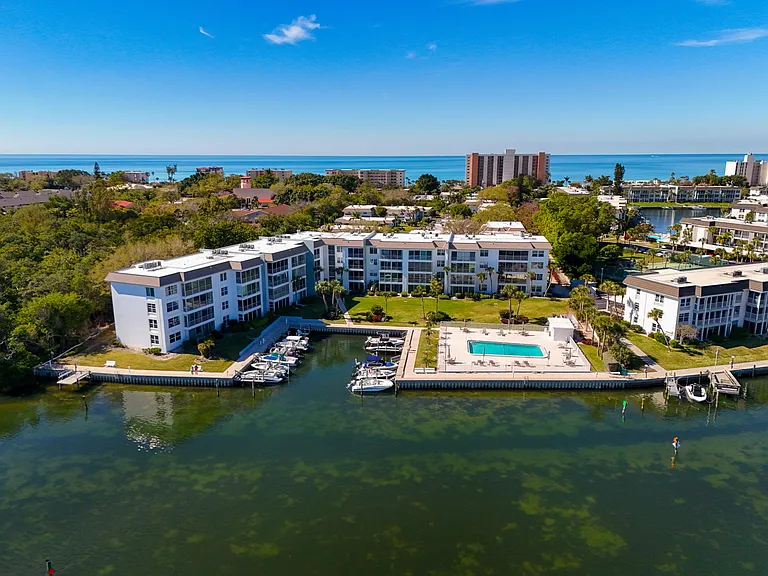Drone view, condo is ground floor on the left side of building with direct views of Bay.
