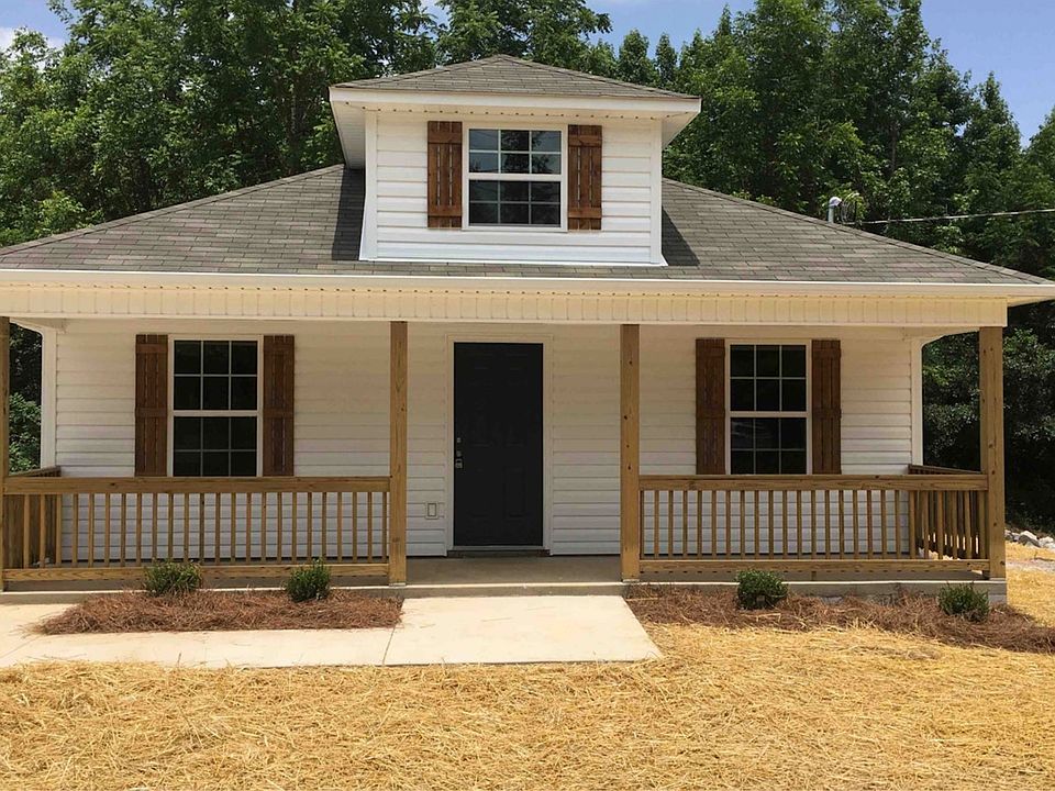 Front - Beautiful, shady porch. Patio to side.