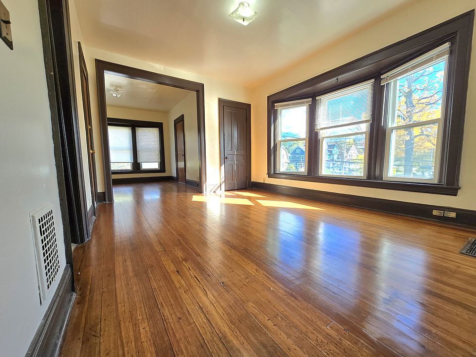 Expansive living and dining area with an open flow that leads into a bright den_ideal for a home office, reading nook, or extra lounge space