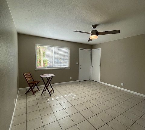 Living area from the interior looking out and coat closet is directly next to front door. Fan has a remote control.