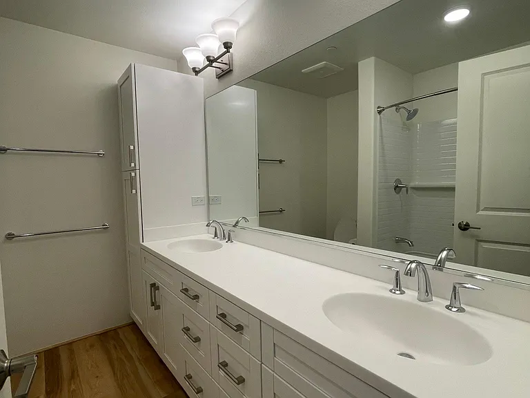 Master bath with his and her sinks plus linen storage area