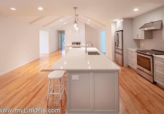 Kitchen open to the Great Room area with masonry fireplace