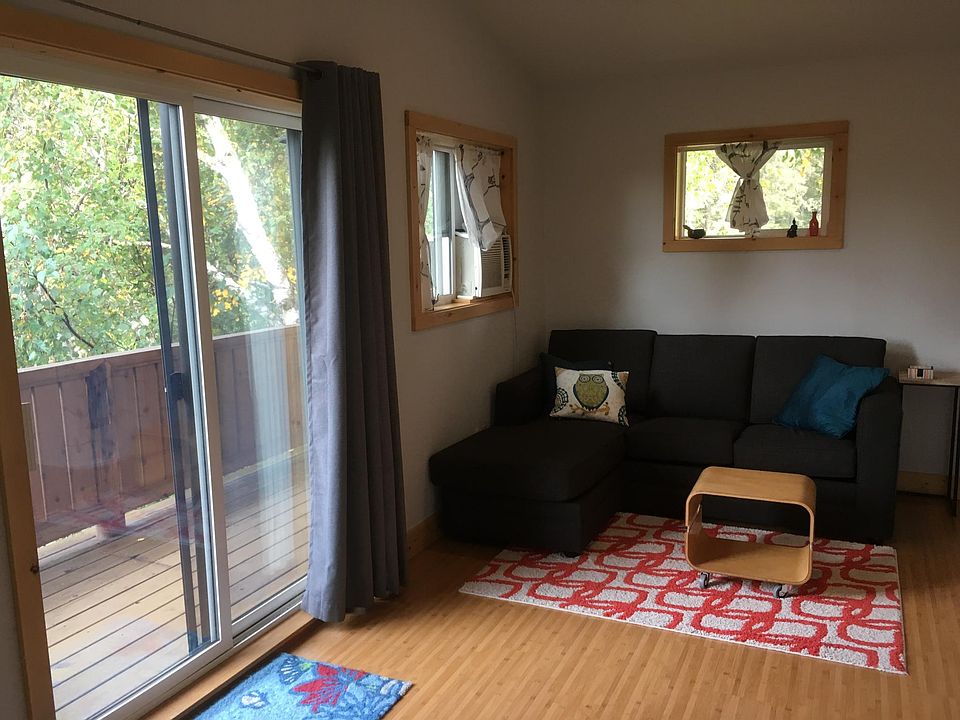 Bamboo laminate flooring and natural light. This couch can stay or be removed.