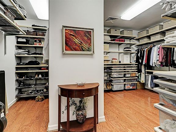 The primary closet is a massive 16' x 11' and has been upgraded with an Elfa organizing system that can be customized and expanded. Upgraded lighting allows flexible use of this space for working as well.