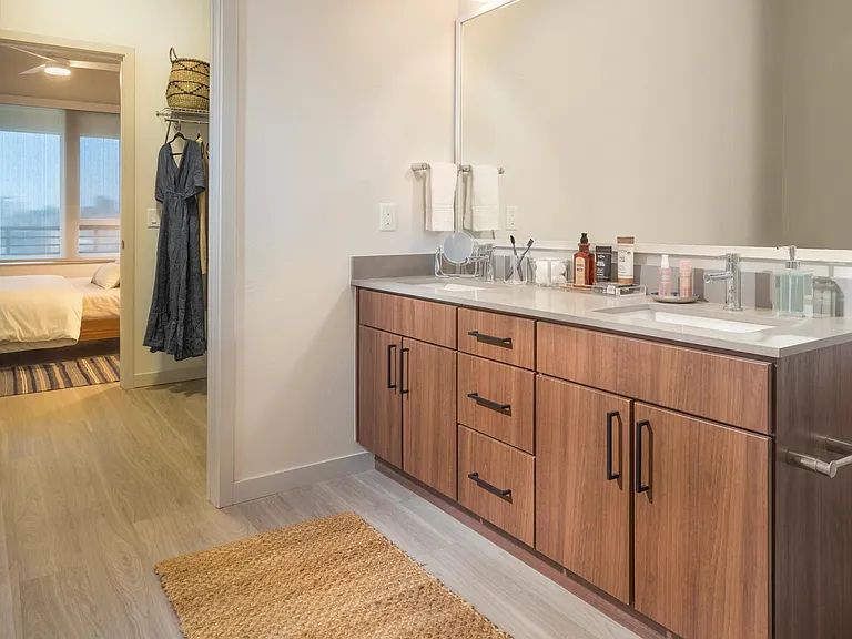 Double sink bathrooms with wood grain vanities