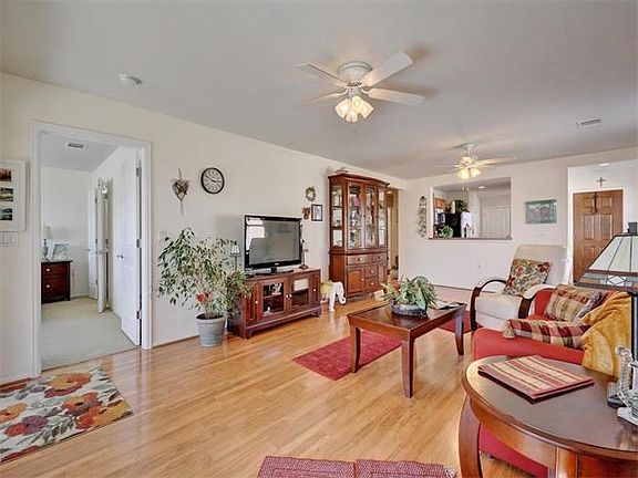 Honey colored wood laminate flooring runs through main areas.