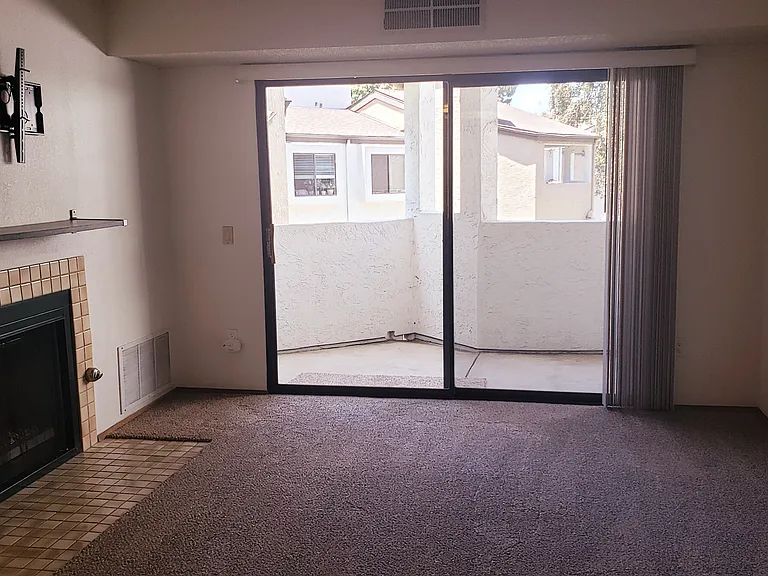 Living room with fireplace and sliding door to balcony
