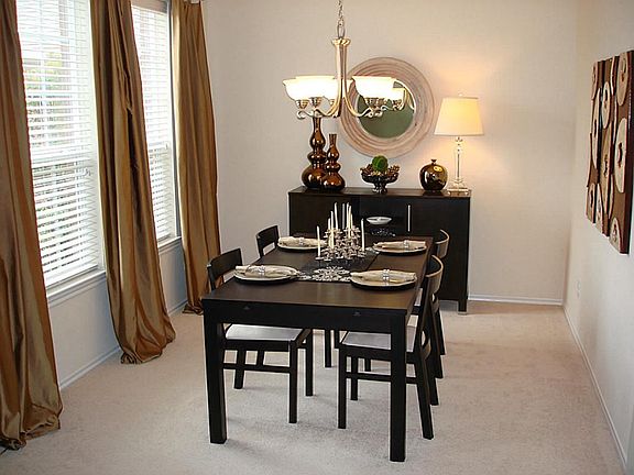 The formal dining offers neutral colors and updated light fixtures