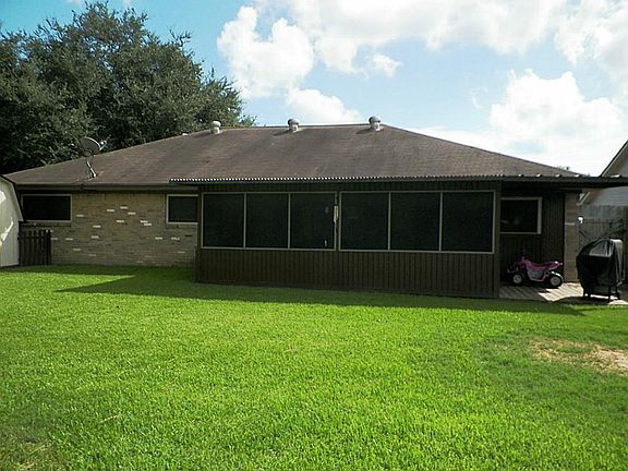 Big backyard looking toward the screened in deck and the extra covered deck for bbq pit and outdoor riding toys.