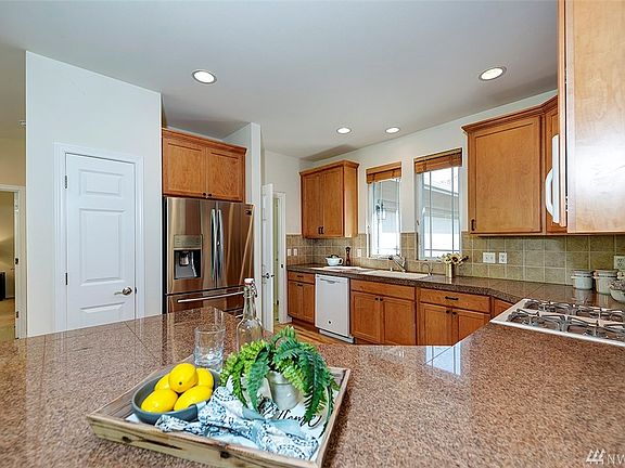 That is the pantry to the left of the refrigerator. The door to the right leads to the laundry/mud room which connects to the garage.