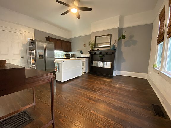 View of spacious kitchen and living area when you enter apartment from private porch