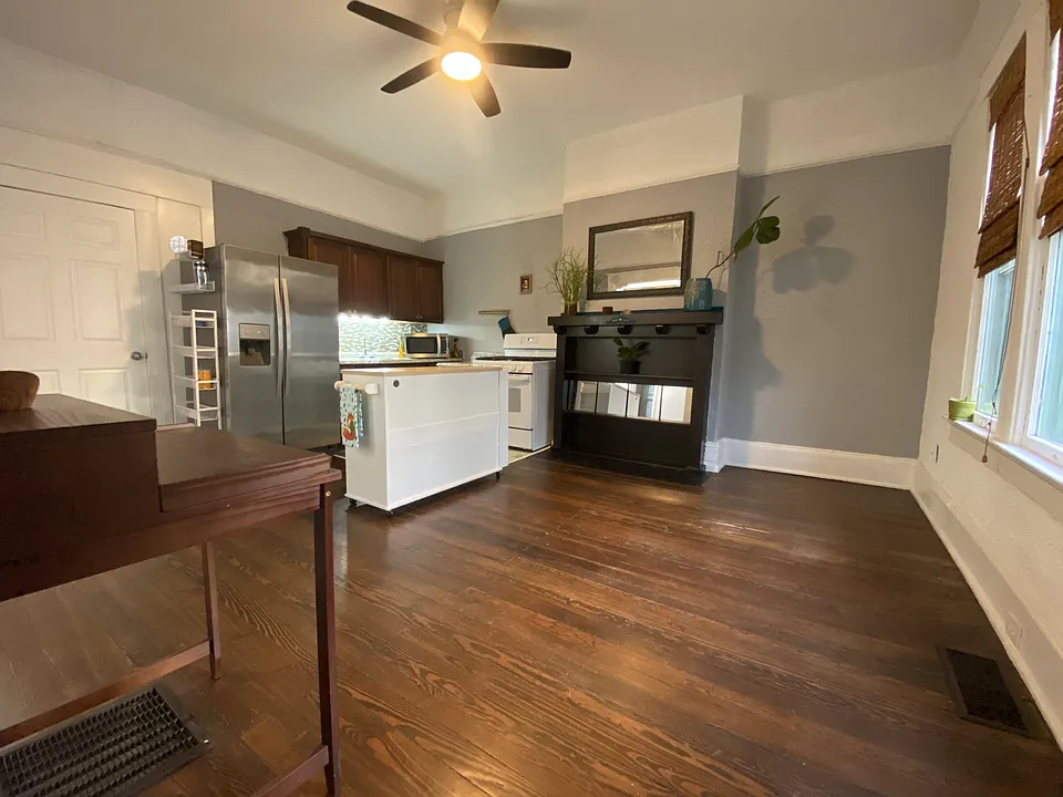 View of spacious kitchen and living area when you enter apartment from private porch
