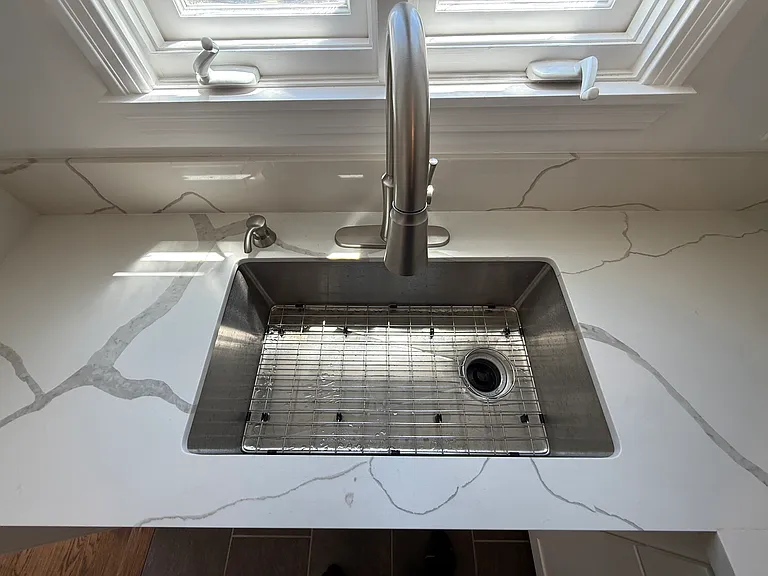 Stainless Steel Undermount Sink for easy clean up. Kitchen Faucet doubles as pull-out sprayer. Soap Pump also included.