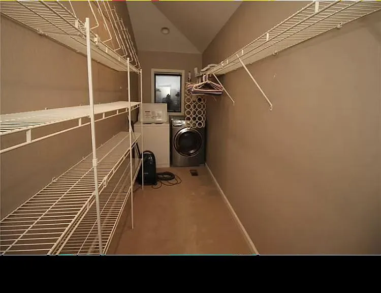 Walk in closet with laundry room in the back