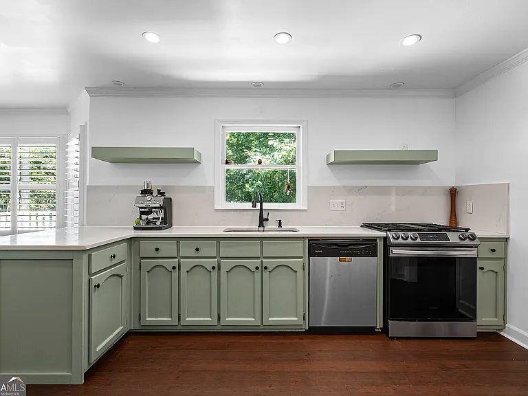 Kitchen with Floating Shelves, Two Pantries, Gas Range, Oven, Refrigerator, and Bay Windows