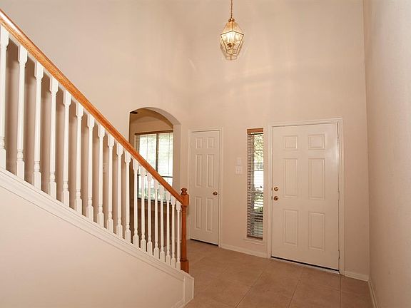 A two-story entrance and a grand stairway welcome you home...