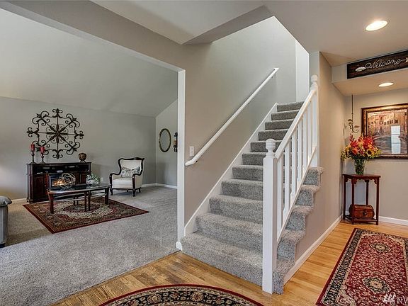 Open entry with Newer carpet, classic warm hardwood floors, and fresh stylish paint palette greets you right away!