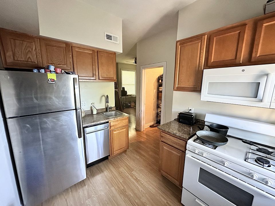 The kitchen has new appliances and wood floor