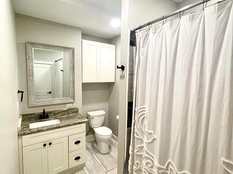 Guest bathroom (1st floor) with jetted tub/shower.