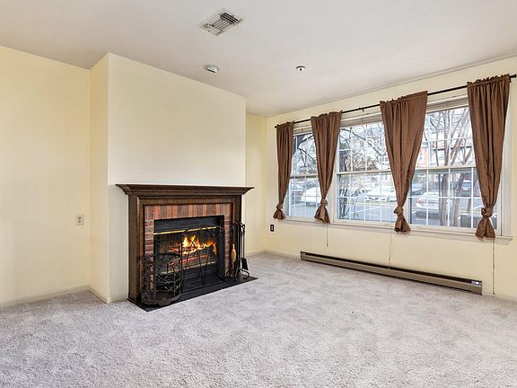 Beautiful living room with triple window and fireplace
