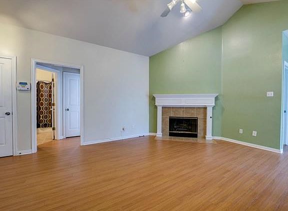 The living room features a fireplace with wood mantel.