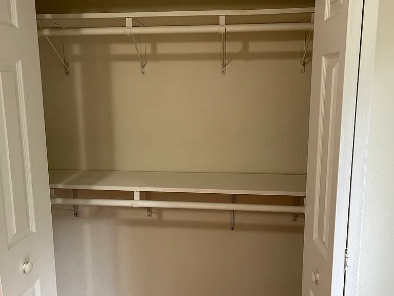 Standard size closet with some shelving in 2nd bedroom