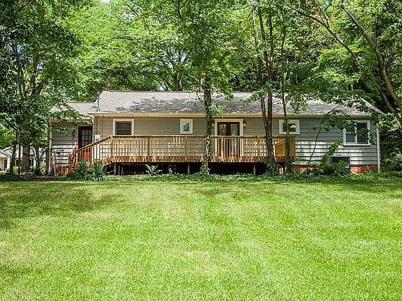 Back view with large deck and patio.