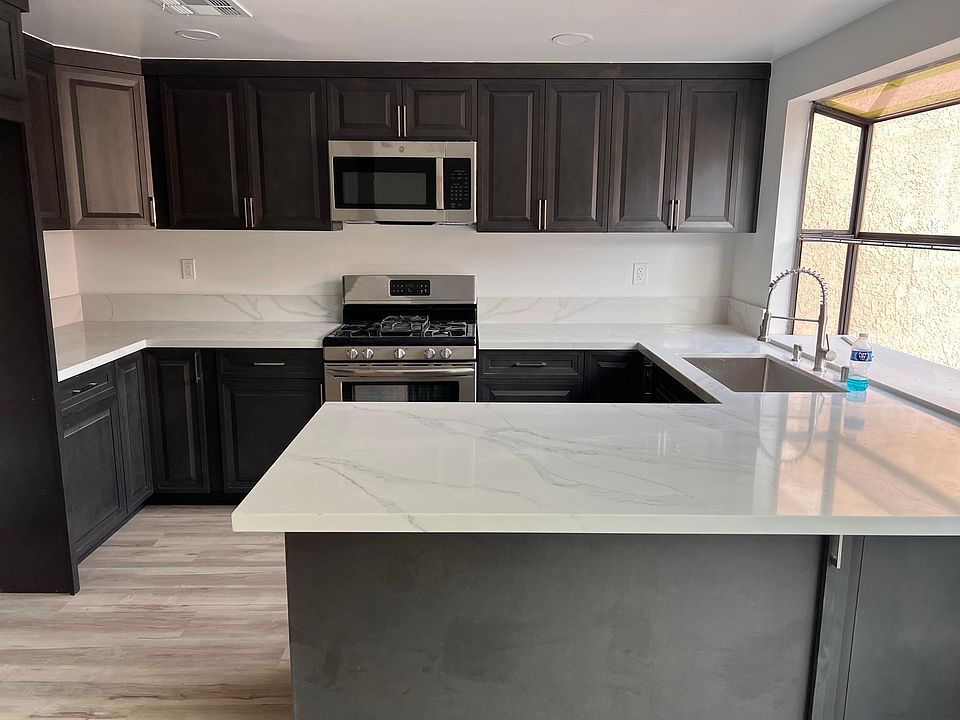 Brand New Kitchen with stove and Hood Microwave and dish washer . and quartz counter top .